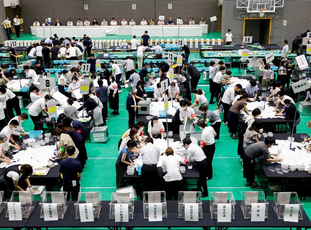 Election officials count votes at a ballot counting centre for Japan's upper house election in Tokyo, Japan, July 20, 2025. REUTERS/Manami Yamada