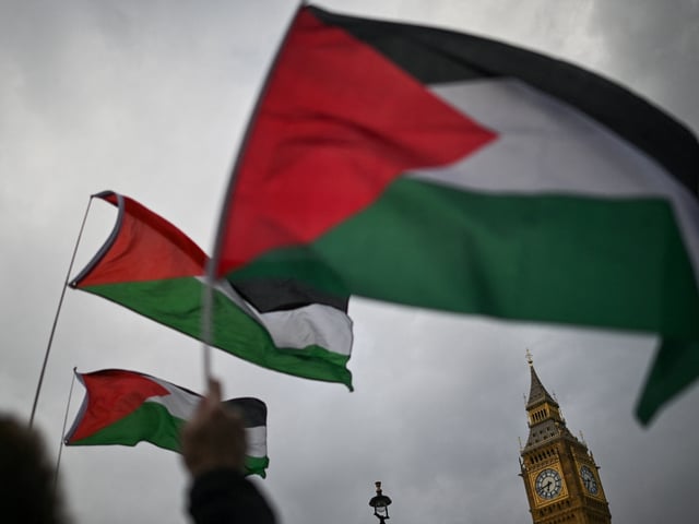 TOPSHOT - Pro-Palestinian activists and supporters hold placards and Palestinian flags as they gather in front of The Elizabeth Tower, commonly known by the name of the clock's bell "Big Ben", at the Palace of Westminster, home to the Houses of Parliament, in central London, on April 17, 2024 to protest against the export of arms from Britain to Israel. (Photo by JUSTIN TALLIS / AFP) (Photo by JUSTIN TALLIS/AFP via Getty Images)