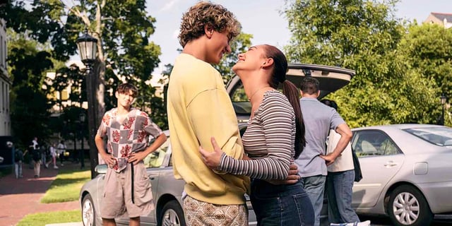 Jeremiah Fisher and Belly Conklin hugging and smiling at each other while Steven Conklin watches, annoyed, in The Summer I Turned Pretty TSITP Season 3