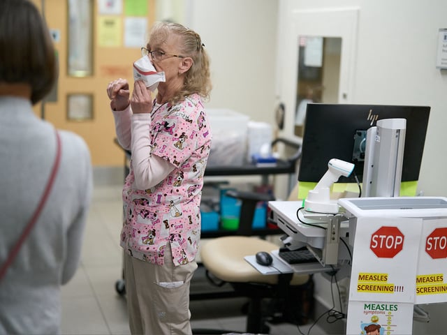 A nurse demonstrates how to put on mask at measles screening point Victoria Hospital in London Ontario July 9 2025. Canada which officially eradicated 1998 has recorded more cases of the virus this year than any other Western country according World Health Organization figures updated month. Different communities have been hit but experts link severity outbreak primarily conservative Mennonite provinces and Alberta long opposed vaccines. (Photo by Geoff Robins / AFP) - FTP CLARIN AFP__20250718__66KG2AQ__v1__HighRes__CanadaVirusMeasles.jpg Z FClarin Fotoclarin
