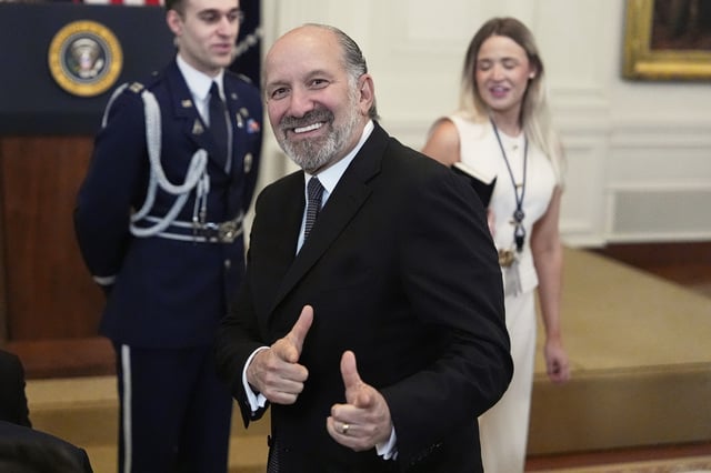 Commerce Secretary Howard Lutnick gestures as he attends an event for the signing of the GENIUS Act, a bill that regulates stablecoins, a type of cryptocurrency, in the East Room of the White House, Friday, July 18, 2025, in Washington. (AP Photo/Alex Brandon)
