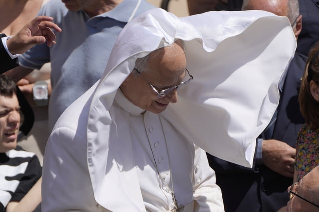 A gust of wind blows Pope Leo XIV's mantel at the end of the noon Angelus prayer in the square in front of the Apostolic Palace in Castel Gandolfo, Italy, Sunday, July 20, 2025. (AP Photo/Gregorio Borgia)
