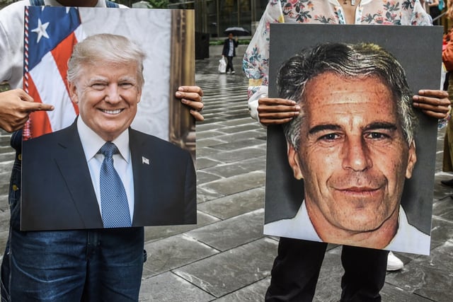 Protesters with pictures of Jeffrey Epstein and President Donald Trump in front of the Federal courthouse on July 8, 2019 in New York City.