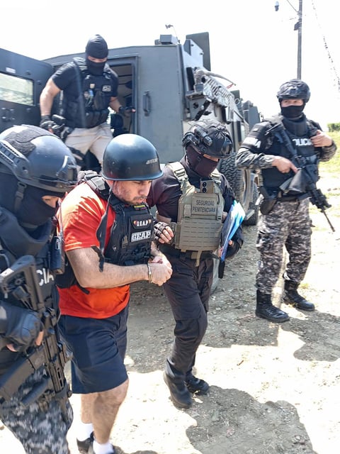 This photo provided by Ecuador Prison Authorities on Sunday, July 20, 2025, shows Jose Adolfo Macias, better known as “Fito,” being handed over to US officials in Guayaquil, Ecuador.