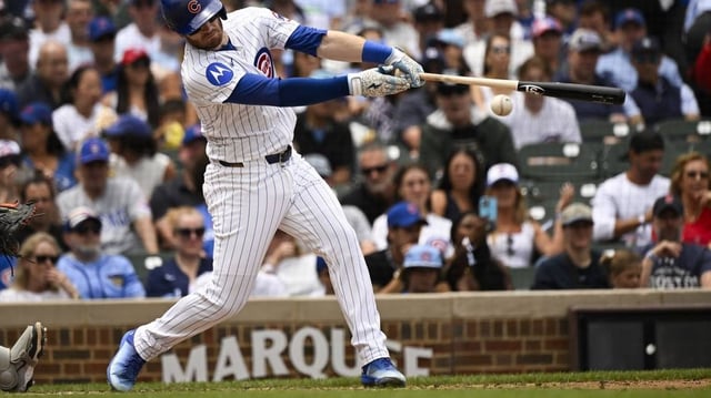Jul 20, 2025; Chicago, Illinois, USA;  Chicago Cubs outfielder Ian Happ (8) hits an RBI single against the Boston Red Sox during the second inning at Wrigley Field. Mandatory Credit: Matt Marton-Imagn Images