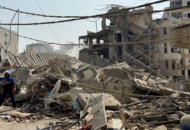A man stands next to rubble at a damaged site in the aftermath of Israeli strikes, in Beirut's southern suburbs, Lebanon June 6, 2025. REUTERS/Ali Hankir/File Photo