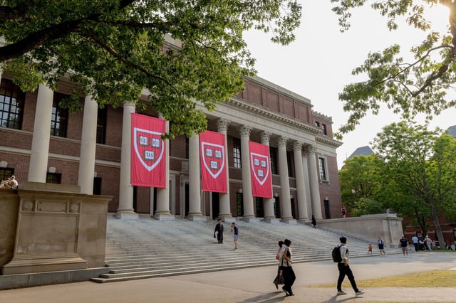 People walk past the Widener Library on the Harvard Campus in Cambridge, Massachusetts, on June 4.
