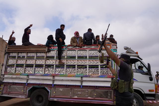 Bedouin families ride on a vehicle as they leave the village of Al-Mazraa, as residents reported calm in Syria's Sweida on Sunday after the Islamist-led government announced that Bedouin fighters had withdrawn from the predominantly Druze city and a U.S. envoy signaled that a deal to end days of fighting was being implemented, in Sweida, Syria, July 21, 2025. REUTERS/Karam al-Masri