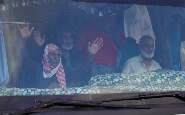 Bedouin families ride in a vehicle as they leave the village of Al-Mazraa, as residents reported calm in Syria's Sweida on Sunday after the Islamist-led government announced that Bedouin fighters had withdrawn from the predominantly Druze city and a U.S. envoy signaled that a deal to end days of fighting was being implemented, in Sweida, Syria, July 21, 2025. REUTERS/Karam al-Masri