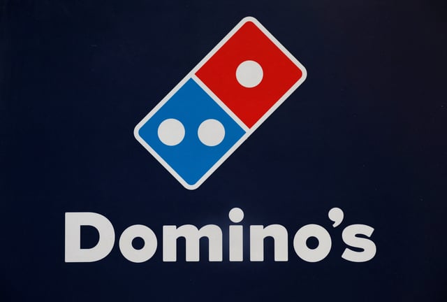 A Domino's pizza logo is pictured inside a restaurant in Noida, India, July 4, 2023. REUTERS/Adnan Abidi/File Photo