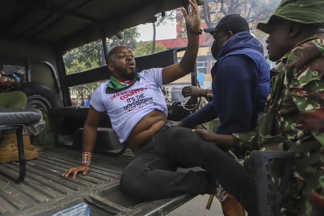 FILE - Police arrest activist Boniface Mwangi during a protest held to commemorate one month since youths were killed on June 25, outside parliament in Kenya's capital Nairobi, Thursday, July 25, 2024. (AP Photo/Andrew Kasuku, file)