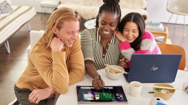 People using Windows 11 laptops and looking happy