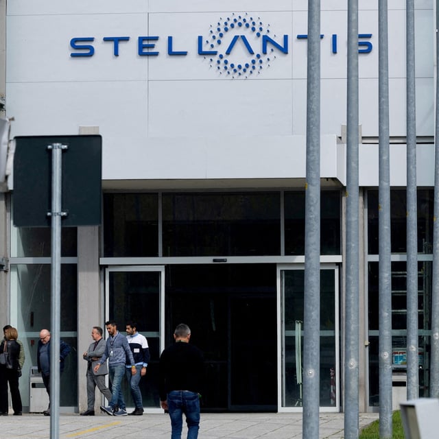 FILE PHOTO: People walk next to the N.13 gate of the Franco-Italian automaker Stellantis factory of Mirafiori, in Turin, Italy October 15, 2024. REUTERS/Remo Casilli/File Photo