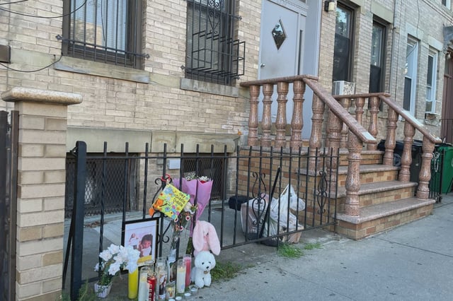 A memorial stands outside the building in Ridgewood, Queens, where a mother and her 2-year-old daughter were killed during a domestic incident on July 19, 2025.