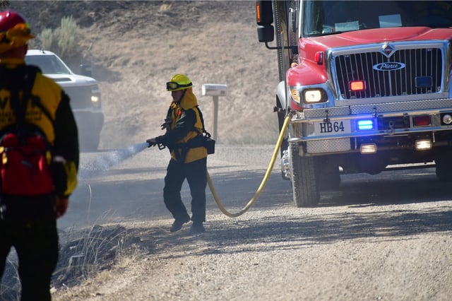 A firefighter sprays water to contain the blaze in Oregon in this image posted to X by the Oregon State Fire Marshal on July 19.