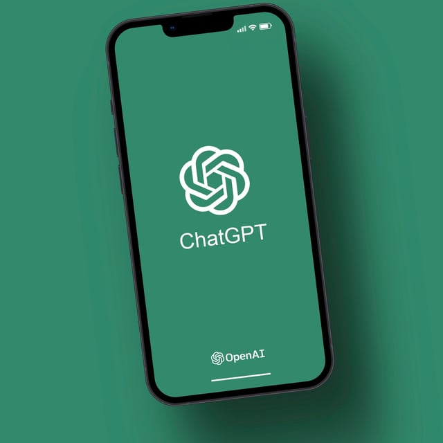 An iPhone showing the ChatGPT logo on its screen