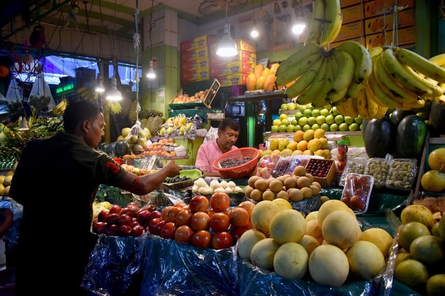 A person buys fruits inside a market in Kolkata, India, on May 25, 2025. (Photo by Sudipta Das/NurPhoto via Getty Images)