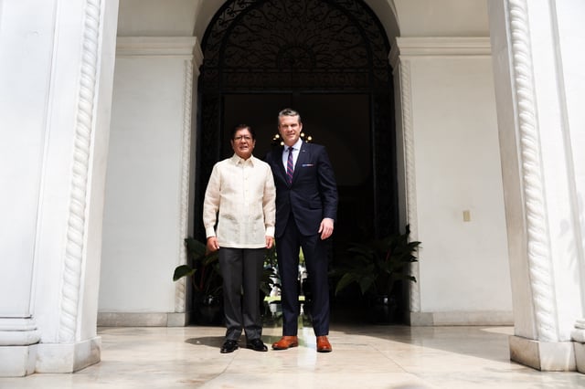 Philippine President Ferdinand Marcos Jr. (L) and U.S. Defense Secretary Pete Hegseth pose during Hegseth&#39;s visit to Malacanang Palace on March 28, 2025, in the Philippine capital, Manila. Marcos will meet President Donald Trump on Tuesday to discuss tariffs and security.