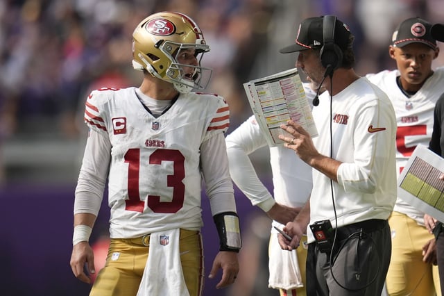 San Francisco 49ers head coach Kyle Shanahan talks with quarterback Brock Purdy (13) during the second half of an NFL football game against the Minnesota Vikings, Sunday, Sept. 15, 2024, in Minneapolis. The Vikings won 23-17. (AP Photo/Abbie Parr)