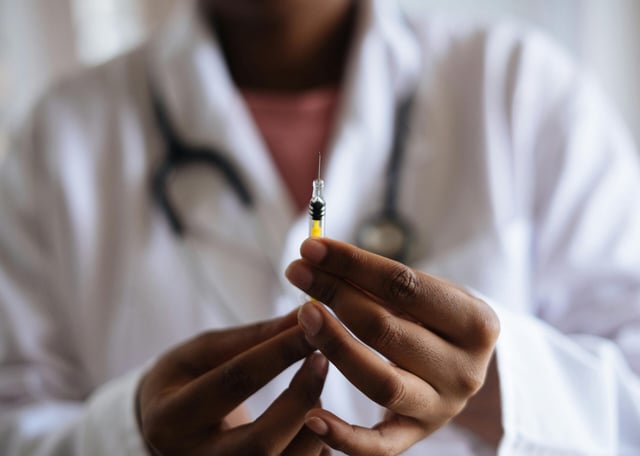 Doctor holding vaccine injection