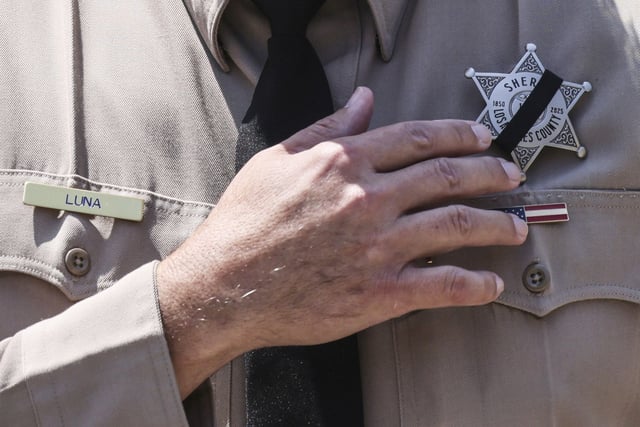 Los Angeles County Sheriff Robert Luna wears a band over his badge after three members of the department were killed in an explosion at a training facility on Friday, July 18, 2025, in Los Angeles. (AP Photo/Etienne Laurent)