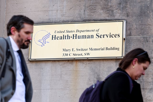 Employees of the Department of Health and Human Services (HHS) stand outside the Mary E. Switzer Memorial Building, after it was reported that the Trump administration fired staff at the Centers for Disease Control and Prevention and at the Food and Drug Administration, as it embarked on its plan to cut 10,000 jobs at HHS, in Washington, D.C., U.S., April 1, 2025. REUTERS/Kevin Lamarque/File Photo