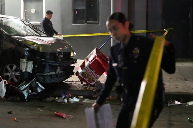 Law enforcement investigate the scene where a vehicle rammed into a crowd of people waiting to enter a nightclub along a busy boulevard in East Hollywood early Saturday, July 19, 2025 injuring several people. (AP Photo/Damian Dovarganes)