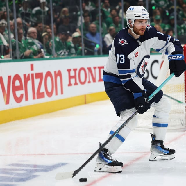 Winnipeg Jets centre Gabriel Vilardi prepares to make a pass as Dallas Stars goaltender Jake Oettinger, right rear, looks on in the second period of Game 4 of a second-round NHL hockey playoff series in Dallas, Tuesday, May 13, 2025. (AP Photo/Gareth Patterson)