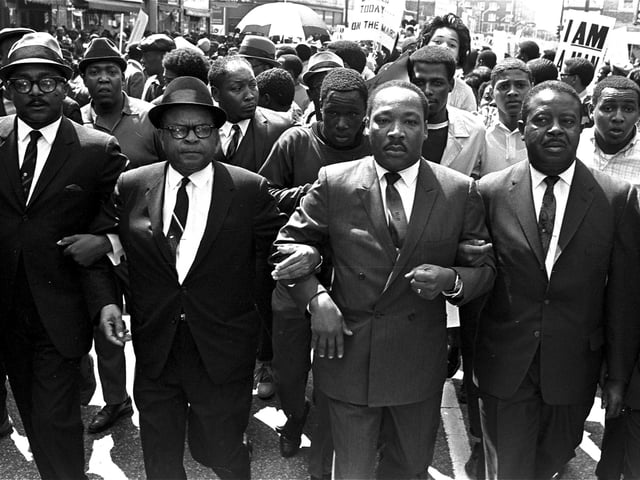 FILE - The Rev. Ralph Abernathy, right, and Bishop Julian Smith, left, flank Dr. Martin Luther King, Jr., during a civil rights march in Memphis, Tenn., March 28, 1968. (AP Photo/Jack Thornell, File)