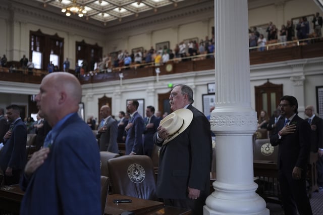 Texas State Rep. Cecil Bell, Jr., R-Magnolia, center and other house member stand for the pledge as the House calls a Special Session, Monday, July 21, 2025, in Austin. (AP Photo/Eric Gay)