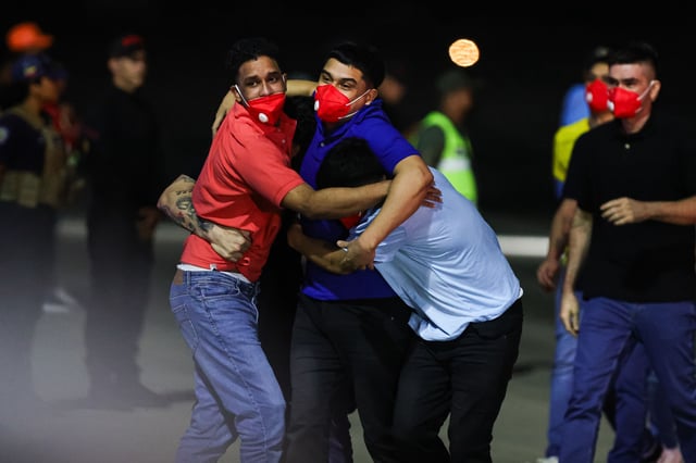 Detained Venezuelans embrace upon arrival at Simon Bolivar International Airport as part of a detainee exchange agreement between Venezuela and United States on July 18, 2025 in Caracas, Venezuela.