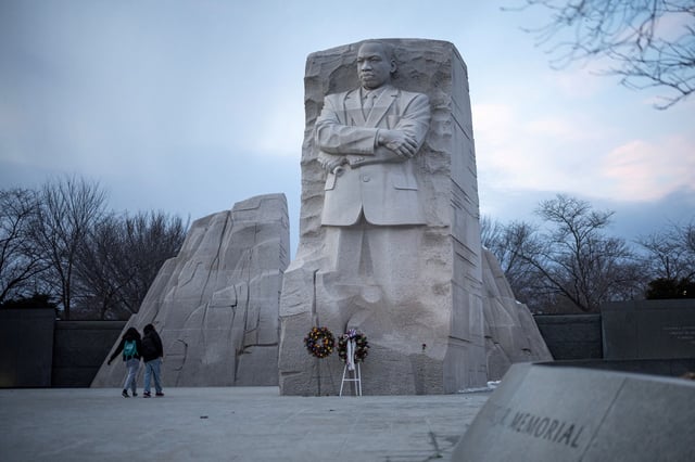 People walk by the Martin Luther King, Jr. Memorial, ahead of the presidential inauguration of U.S. President-elect Donald Trump, in Washington, U.S., January 16, 2025. REUTERS/Marko Djurica/File Photo