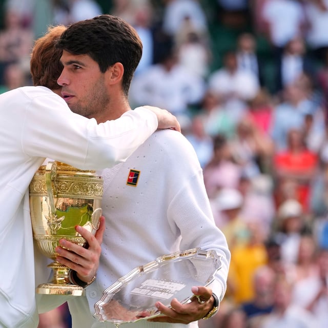 Jannik Sinner of Italy hugs Carlos Alcaraz of Spain after winning the men's singles final match at the Wimbledon Tennis Championships in London, Sunday, July 13, 2025.(AP Photo/Kirsty Wigglesworth)