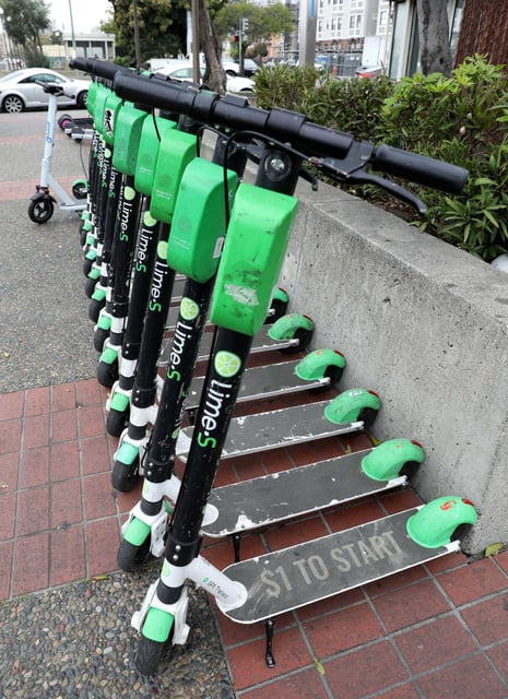 Lime scooters seen lined up at the Lake Merritt Bart station in 2020, in Oakland. A pedestrian died after being struck by a person riding a Lime scooter in downtown San Francisco.