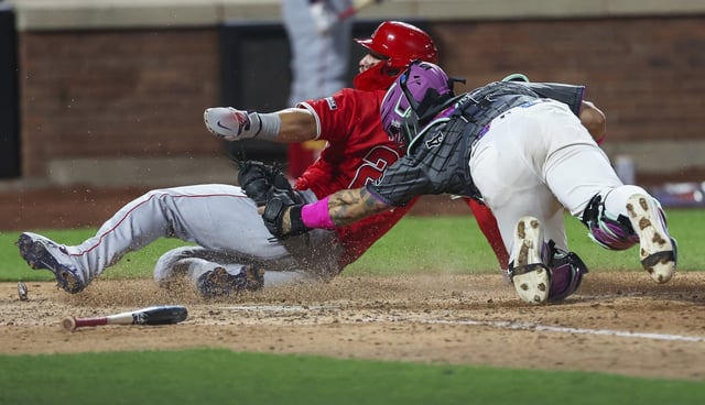 Angels star Mike Trout, left, is tagged out at home plate by New York Mets catcher Francisco Alvarez during the seventh inning on Monday night at Citi Field in New York. (AP Photo/Heather Khalifa)