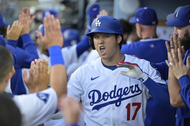 Los Angeles Dodgers’ Shohei Ohtani (17) is congratulated by teammates after hitting a two-run home run against the Minnesota Twins during the first inning of a baseball game in Los Angeles, Monday, July 21, 2025. (AP Photo/Jayne Kamin-Oncea)