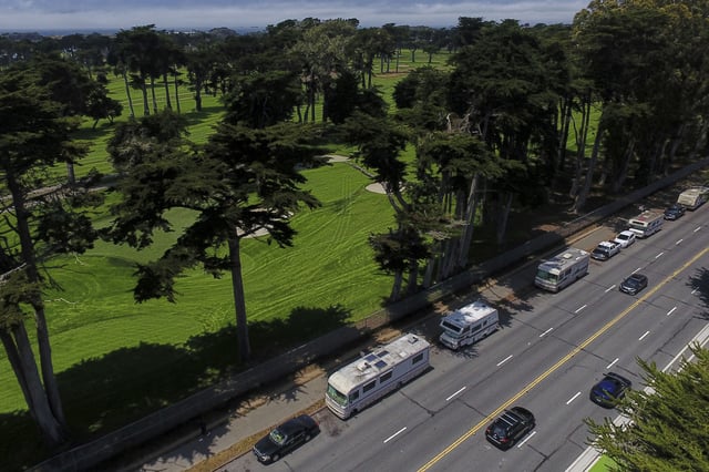Motorists travel past RVs parked on Lake Merced Boulevard in San Francisco, Tuesday, July 15, 2025. (AP Photo/Godofredo A. Vásquez)