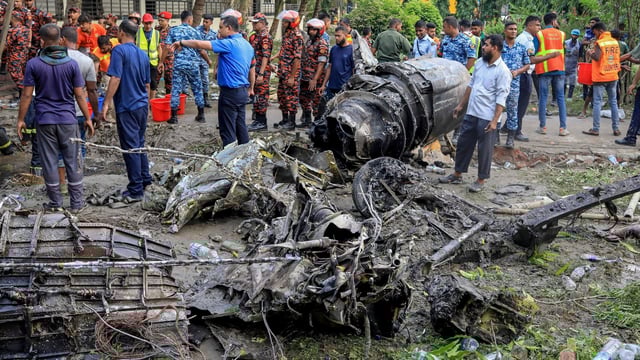Bangladesh's fire service and security personnel conduct a search and rescue operation after an Air Force training jet crashed into a school in Dhaka on July 21, 2025. A Bangladeshi training fighter jet crashed into a school in the capital Dhaka on July 21, killing at least 19 people and injuring dozens more in the country's deadliest aviation accident in decades.