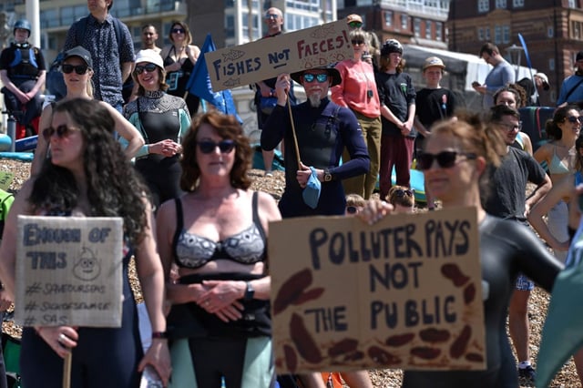 Surfers Against Sewage activist holds a placard reading &#39;Fishes not faeces&#39; during a protest against sewage pollution in Brighton (Photo: Ben Stansall/AFP)