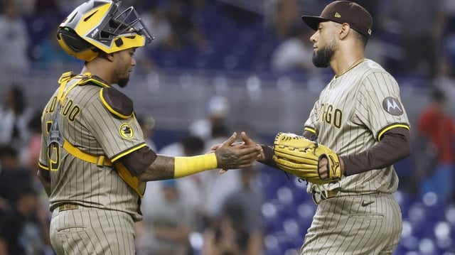 Jul 21, 2025; Miami, Florida, USA;  San Diego Padres catcher Martin Maldonado (15) and relief pitcher Robert Suarez (75) celebrate their win against the Miami Marlins following the game at loanDepot Park. Mandatory Credit: Rhona Wise-Imagn Images