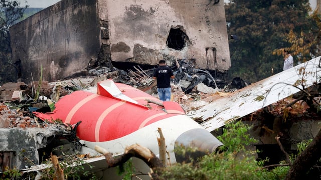 A firefighter stands next to the crashed Air India Boeing 787-8 Dreamliner aircraft, in Ahmedabad.