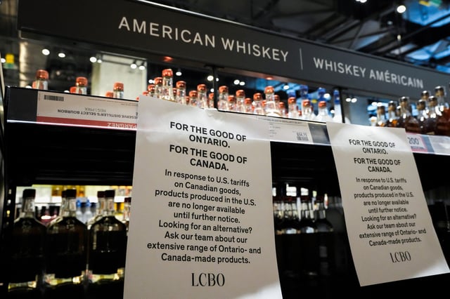A paper notice lists the removal of bottles of U.S. alcohol from the shelves of a Liquor Control Board of Ontario (LCBO) store, as part of retaliatory moves against tariffs announced by U.S. President Donald Trump, in Toronto, Ontario, Canada March 4, 2025. REUTERS/Arlyn McAdorey/File photo
