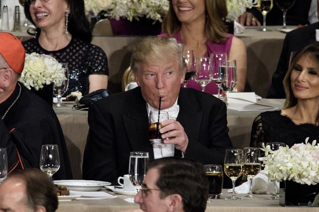 From left Cardinal Timothy Dolan, Archbishop of New York, Republican presidential nominee Donald Trump, Melania Trump and others listen as Democratic presidential nominee Hillary Clinton speaks during the Alfred E. Smith Memorial Foundation Dinner at Waldorf Astoria October 20, 2016 in New York, New York.