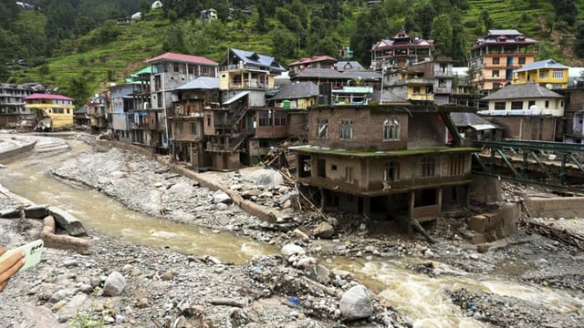Debris and silt near damaged houses at a flood-affected area in Mandi district of Himachal Pradesh on July 6. (PTI)
