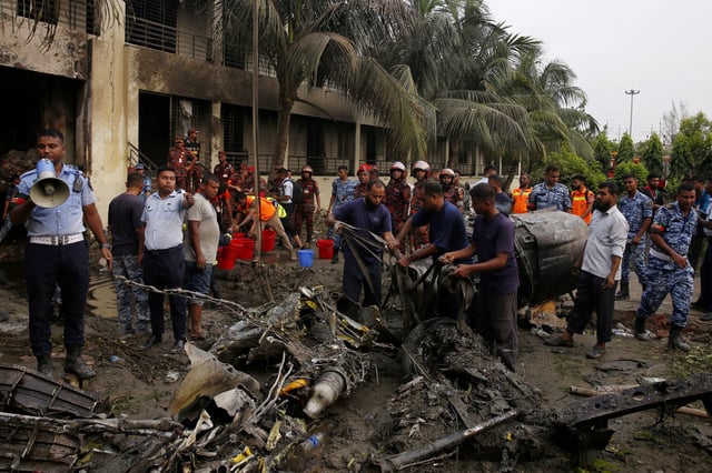 Firefighters work to remove the wreckage from a building, after an air force training aircraft crashed into Milestone College campus, in Dhaka, Bangladesh, July 21, 2025. REUTERS/Stringer/File Photo