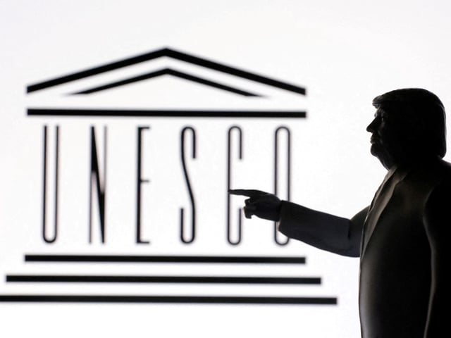 FILE PHOTO: A 3D-printed miniature model of U.S. President Donald Trump with the UNESCO logo in the background is seen in this illustration taken April 23, 2025. REUTERS/Dado Ruvic/Illustration/File Photo