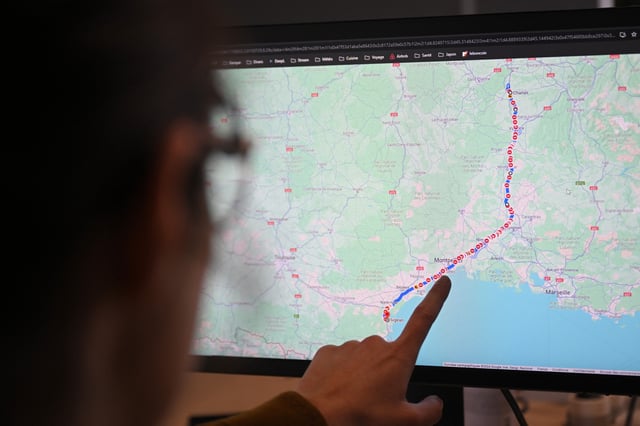 A woman points to a screen displaying the website Google Maps, in Marseille on January 26, 2024.