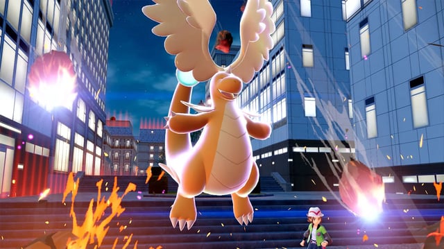 Mega Dragonite, an orange dragon with large wings on its head and a pearl on its tail.