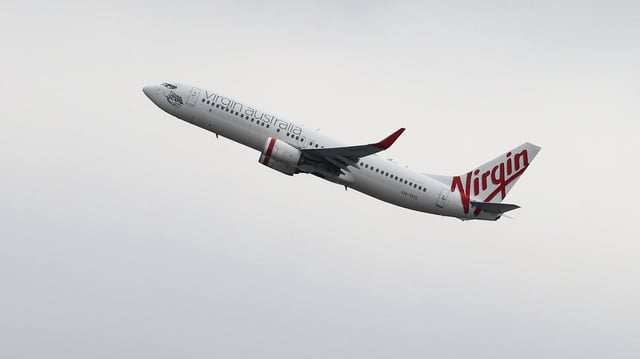 A Virgin Australia flight turned back to Perth after an allegedly naked man knocked over a crew member.