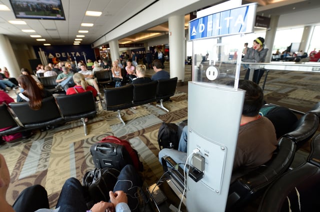 Passengers charge their electronic devices while waiting for flights at Nashville International Airport in this file photo from 2012.